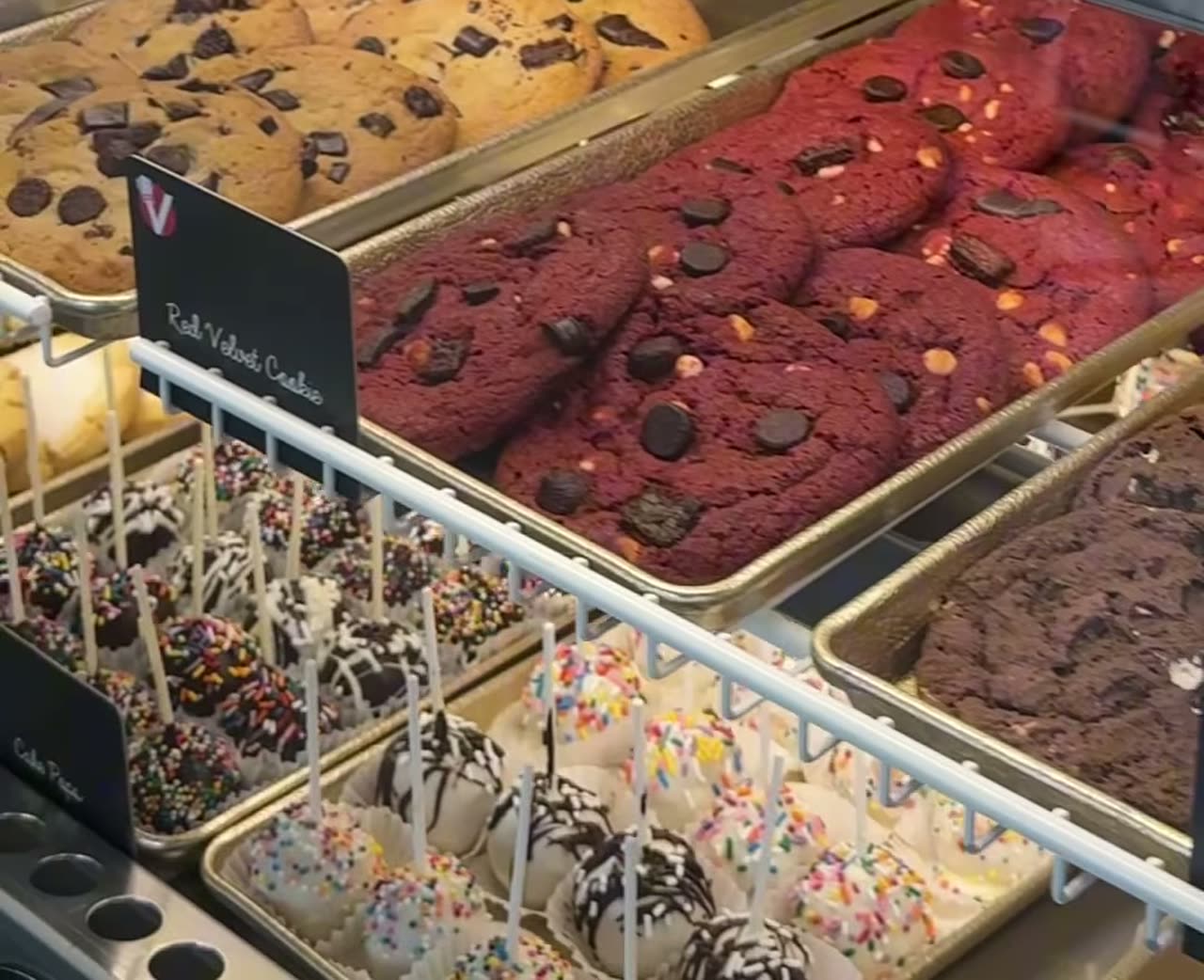 Vicky Bakery dessert case with chocolate cookies, red velvet, and cake pops.